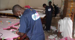 Workers cut materials to make sanitary pads at an AFRIpads factory in Masaka. Photograph: Louise McLoughlin