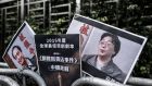 Placards showing missing bookseller Lee Bo (left) and his associate Gui Minhai (right)  outside the China liaison office in Hong Kong. Photograph: Philippe Lopez/AFP/Getty Images