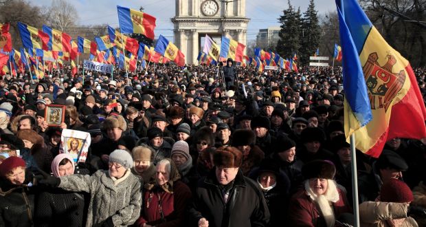 Protesters shout slogans during a large demonstration in Chisinau, Moldotheva, on Sunday. Photograph: Vadim Ghirda/EPA