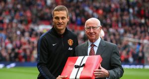 Vidic is presented by Bobby Charlton with an award before his final game for Manchester United in 2014. Photo: Alex Livesey/Getty Images