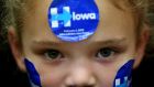 A young supporter wears campaign stickers on her face as Democratic presidential candidate  Hillary Clinton speaks during a ‘get out to caucus’ event at Washington High School on January 30th in Cedar Rapids, Iowa. Photograph: Justin Sullivan/Getty Images