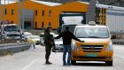 Clampdown: an Israeli soldier checks the documents of a Palestinian passenger of a taxi on its way out of   Ramallah yesterday. Photograph:  Abbas Momani/AFP/Getty Images
