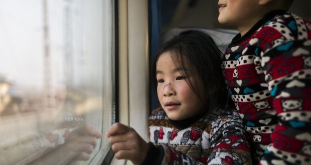 Chinese children in Beijing wait for their train to set off  to their home town for the spring festival, or lunar new year. The auspicious Year of the Monkey begins on February 8th. Photograph: Fred Dufour/AFP/Getty Images