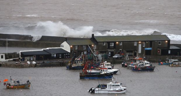 Waves crash against the harbour wall in Lyme Regis, Dorset in England. Photograph: Steve Parsons/PA