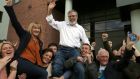 Sinn Féin leader Gerry Adams is held aloft after being re-elected. Photograph: AFP/Getty Images