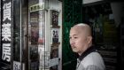 A man stands by a display cabinet of the Causeway Bay bookshop in Hong Kong. Photograph: Philippe Lopez/AFP/Getty Image