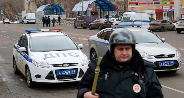 A Russian police officer stands at the site where a woman suspected of murdering a young child was arrested on Monday.  Russian investigators said they had arrested a nanny and charged her with murdering a young child in her care. Photograph: Reuters 