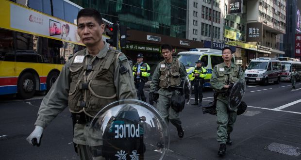 Hong Kong riot police walk along a cordoned-off street on February 9th following overnight clashes between protesters and police in the Mong Kok area. Photograph: Dale de la Rey/AFP/Getty Images