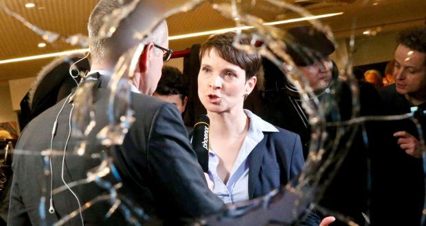 Frauke Petry, chairwoman of the anti-immigration party Alternative for Germany (AfD) is pictured through a broken window after first exit polls in three regional state elections at the AfD party’s election night party in Berlin, Germany yesterday. Photograph: Reuters/Fabrizio Bensch 