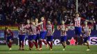 Atletico Madrid players celebrate their shootout win over PSV. Photograph: Afp