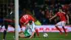 Northern Ireland’s Gareth McAuley (centre) concedes a penalty by fowling Wales’ Simon Church in the area. Photo: Nick Potts/PA Wire. 