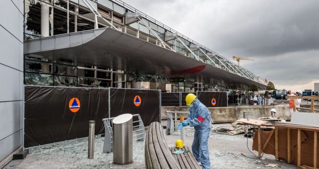 A forensics officer works in front of the damaged Zaventem Airport terminal in Brussels. Photograph: Geert Vanden Wijngaert/AP Photo