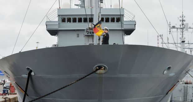 Lt Henning Hauser unfurls the German flag on the bow of the flagship FGS Donau, berthed in Dublin.  Photograph: Alan Betson/The Irish Times