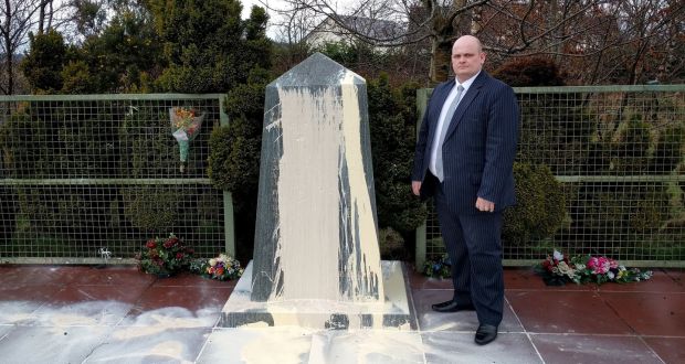  DUP of assembly candidate Ian McCrea standing next to a memorial to the victims of an IRA bomb in Co  Tyrone after it was vandalised. Photograph: DUP/PA Wire
