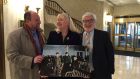 Paul Linehan (Annie Moore’s Irish relative), genealogist Megan Smokenyak and Michael Schulman (Annie Moore’s American relative) with a photograph of Annie Moore arriving at Ellis Island on January 1st, 1892 with her brothers, Anthony and Philip. Photograph: Megan Smolenyak