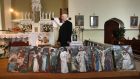 Fr Martin McNamara with the stolen paintings which were returned to Kiltullagh Church in east Galway on Wednesday. Photograph: Joe O’Shaughnessy