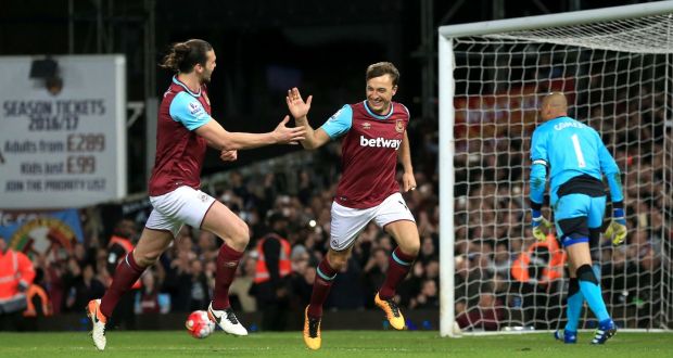 Andy Carroll and Mark Noble celebrate West Ham’s third against Watford. Photograph: PA