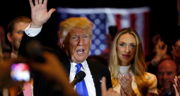 Republican US presidential candidate and businessman Donald Trump waves  to supporters 