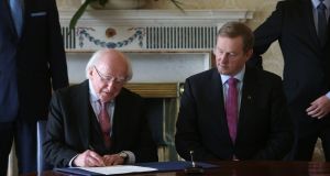 Newly elected Taoiseach Enda Kenny (right) with President Michael D. Higgins at Aras an Uachtarain as he received his seal of office. Photograph: Brian Lawless/PA Wire.