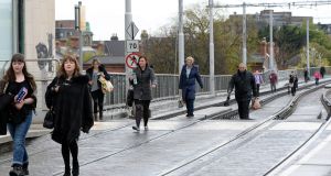 Commuters make their way into Dublin city centre along otherwise  empty  Luas lines near Harcourt Street during a strike late last month. Photograph: Eric Luke/The Irish Times