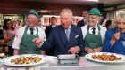  Prince Charles and Camilla, the Duchess of Cornwall, sample award-winning sausages made by brothers Diarmuid (left) and Ernan McGettigan at their butcher’s shop in Donegal town. Photograph: Brian Lawless/PA Wire