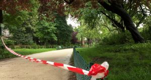 White-and-red tape is strung across a sandy pathway through Park Monceau after a lightning stike, in Paris, Saturday.  Photograph: AP 
