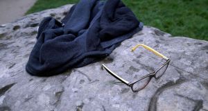 A child’s glasses and a jacket lie on a rock in the Park Monceau, after a lightning strike in Paris. Photograph: AP 
