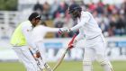 Sri Lanka’s Dimuth Karunaratne (R) exchanges his bat on the third day of the second test cricket match between England and Sri Lanka at the Riverside in Chester Le Street, north east England on Sunday. Photograph: Scott Heppel/AFP 