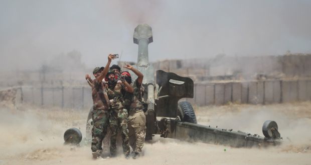 Shia fighters take a selfie while firing artillery towards Islamic State militants near Falluja, Iraq, on Sunday. Photograph: Alaa Al-Marjani/Reuters