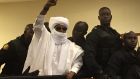 Chad’s former dictator Hissène Habré raises his hand during court proceedings in Dakar, Senegal, on Monday: he was sentenced  to life in prison. Photograph: Carley Petesch/AP Photo