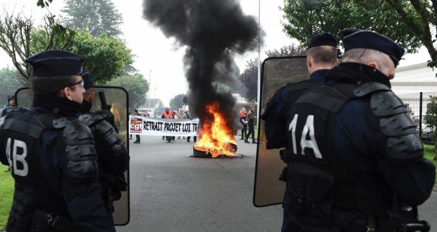 French police stand in front of CGT union members during a protest at a factory in Saint Amand les Eaux, northern France. Photograph: AFP Photo