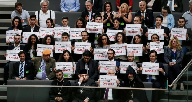 Members of the Armenian community in Germany hold up signs reading ‘Recognition now says thanks’ during a session of the Bundestag. Photograph: Reuters