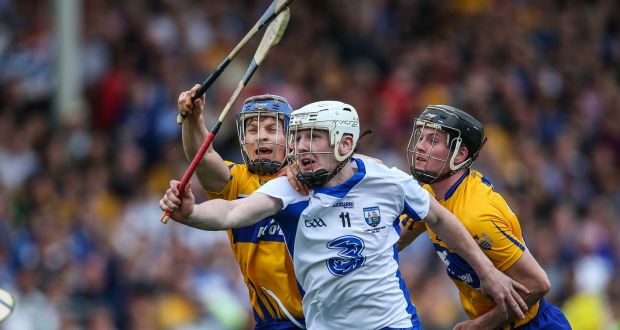 Clare’s Podge Collins  tackles Waterford’s Shane Bennett during the league final replay. Photograph: Cathal Noonan/Inpho