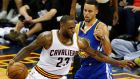 LeBron James holds off Stephen Curry during the NBA Finals game three. Photograph: Epa