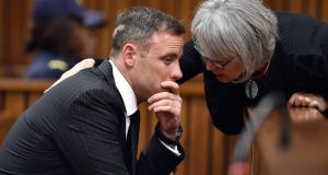South African Paralympian Oscar Pistorius (L) is comforted by an unknown woman inside the high court in Pretoria on June 13th, 2016 minutes before the start of the sentencing hearing set to send him back to jail for murdering his girlfriend three years ago. Photograph: Phill Magakoe/Getty Images