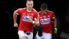 Cork players, led by Paul Kerrigan,  take to the field in Semple Stadium, Thurles. Photograph: Ryan Byrne/Inpho