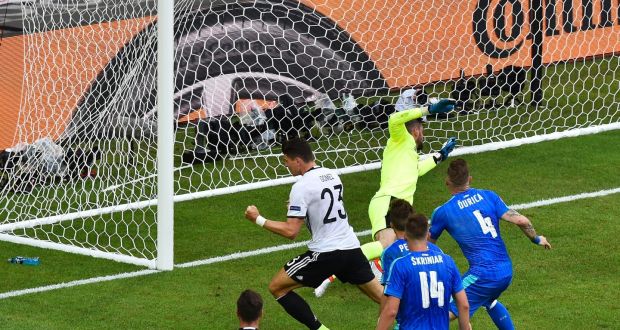 Germany’s forward Mario Gomez scores against Slovakia’s goalkeeper Matus Kozacik during the Euro 2016 round of 16 football match between Germany and Slovakia at the Pierre-Mauroy stadium in Villeneuve-d’Ascq, Lille. Photo: Denis Charlet/Getty Images