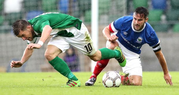 Linfield’s Andrew Waterworth gets the better of  Cork’s Steven Beattie. Photo: William Cherry/Inpho