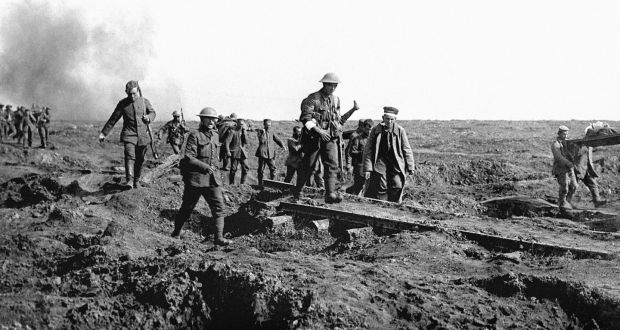 German prisoners help to carry British wounded back to their trenches after an attack by the 14th (Irish) Corps on Bavarian units holding Ginchy during the Battle of the Somme. 