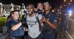 Police arrest activist DeRay McKesson during a protest along Airline Highway, a major road that passes in front of the Baton Rouge police department headquarters on Saturday in Baton Rouge, Louisiana. Photograph: AP