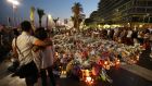 People stand in front of  a makeshift memorial in Nice four days after the attack on July 14th by Mohamed Lahouaiej Bouhlel that left 84 people dead. Photograph: Valery Hache//AFP/Getty Images