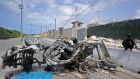 Somali soldiers stands on guard next to the wreckage of a car bomb outside the UN’s office in Mogadishu. Photograph: AFP