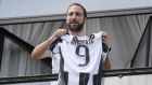 Juventus’ forward Gonzalo Higuain from Argentina holds his jersey at the Juventus’ headquarter in Turin. Photo: Marco Bertorello/Getty Images
