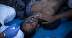 A man gasps for breath after being pulled from the ocean. Photograph: mathieu willcocks/moas