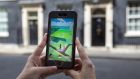 People are playing the  Pokémenon Go game in such inappropriate places as Arlington Cemetery in Virginia,  Auschwicz in Poland and (above) Downing Street in London.   Photograph: Carl Court/Getty Images