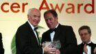 Liam Tuohy receives a Hall of Fame Award from Brian Kerr in 2003. Tuohy passed away on Saturday. Photograph: Andrew Paton/Inpho