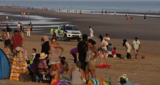 Police officers on Camber Sands near Rye, East Sussex after five men died after being pulled from the sea on the hottest day of the year. Photograph: Gareth Fuller/PA Wire 