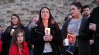 Widow Joanne McGibbon (centre) with her daughters Michaela and Seana and at a vigil in the grounds of Holy Cross Church, Ardoyne for Michael McGibbon. who was shot dead in North Belfast earlier this year. “She made a heartfelt appeal for change in her community, so that paramilitary groups could no longer try to control people through fear, intimidation and murder.”