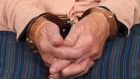 Close up photo of a handcuffed elderly woman. Photograph: iStock