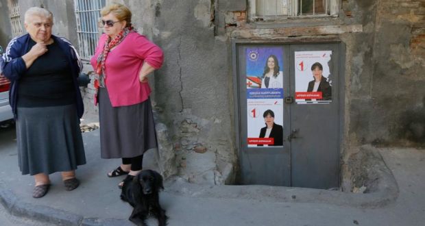 Two women stand in front of election posters of opposition candidate Sofio Giorgadze and Ketevan Mamulshvili of the ruling Georgian Dream party, in Tbilisi. Photograph: Zurab Kurtsikidze/EPA